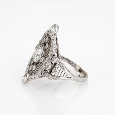 an art deco diamond ring, with three stones in the center and two rows of diamonds on