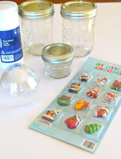 mason jars and other crafting supplies on a white table with labels for christmas decorations