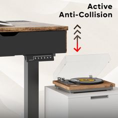 a record player sitting on top of a table next to a turntable with an active anti - collision button