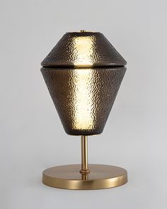 a table lamp that is on top of a stand