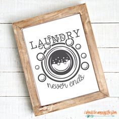 the laundry never ends sign is hanging on a white wooden wall next to a wood frame