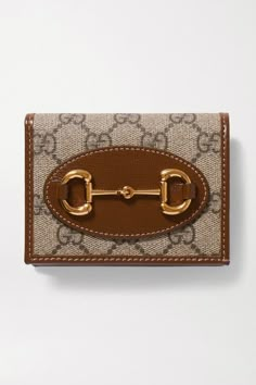 Gucci's petite wallet has been made in Italy from the brand's monogram-printed coated-canvas and detailed with signature '1955' horsebit hardware. Inside, there are six card slots, plus a zipped pocket for coins and receipts. The leather trims provide reinforcement, so it'll age well and last for years. Wear it with: Loewe Coat, Khaite Jeans, Bottega Veneta Sweater. -- Beige and dark-brown coated-canvas, brown leather (Calf) - Snap-fastening front flap - Made in Italy Sac Gucci Horsebit 1955, Luxury Designer Wallets, Gucci Inspired Wallet, Luxury Leather Wallets, Gucci Key Wallet, Gucci Pouchette Bag, Brown Gucci Wallet, Gucci Wallets For Men, Luxury Leather Wallet