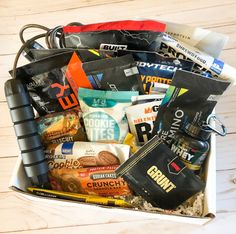 an open box filled with snacks on top of a wooden table