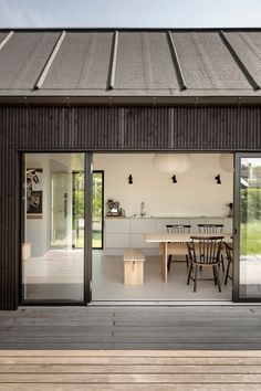 an outdoor dining area with sliding glass doors leading to the patio and outside decking