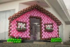 a house made out of balloons with the letter e on it's front door