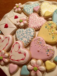 a white plate topped with lots of decorated cookies