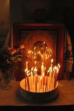 there is a cake with many lit candles on it