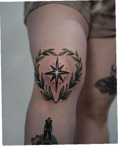 a woman's thigh with a star and wreath tattoo on her left side leg