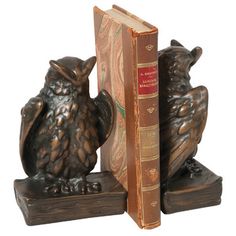 two owl bookends are sitting next to each other