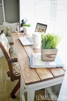 a wooden table topped with a laptop computer