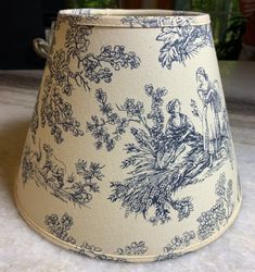 a blue and white lamp shade sitting on top of a table