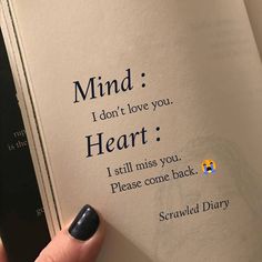 a hand holding an open book with the words mind i don't love you heart