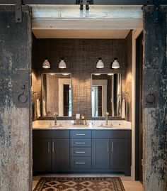 a large bathroom with double sinks and mirrors