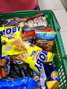 a shopping cart filled with chips and snacks