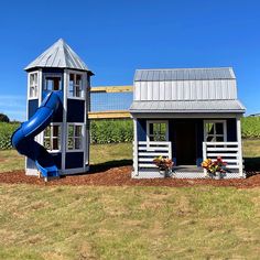 a small house with a slide in the yard