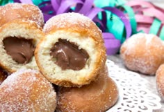 chocolate filled doughnut holes on a white doily