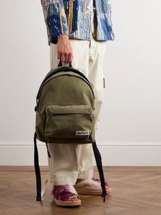 READYMADE's backpack is made from vintage canvas used for duffle bags in the US Army. Trimmed with nylon for extra durability, it's fitted with an internal laptop sleeve and a front zipped pocket to easily access the essentials. The distressed handle gives it a cool, worn-in feel. Army Backpack, Canvas Backpack Men, Mesh Backpack, Embroidered Canvas, Latest Bags, Backpack Women, Canvas Messenger Bag, Travel Logo, Duffle Bags