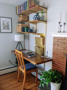 a wooden desk sitting next to a fire place