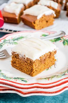 a piece of pumpkin cake on a plate with a fork and more in the background