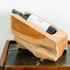 a bottle of wine in a wooden holder