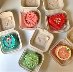 there are many different shaped cupcakes in the trays on the table together