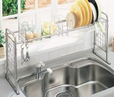 a kitchen sink that has some dishes in it