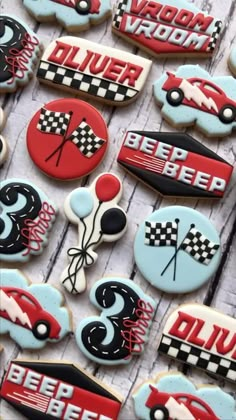 decorated cookies with racing cars and flags are on the table in front of each other