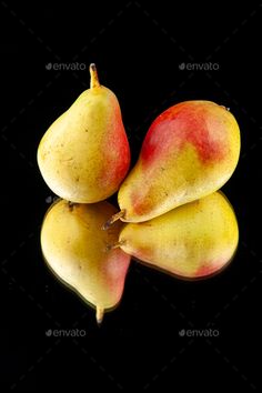 three pears on a black background with reflection - stock photo - images in gallery