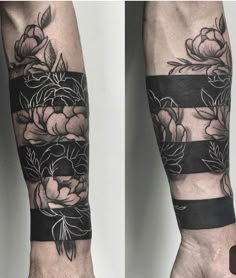 two hands with black and white flowers on them