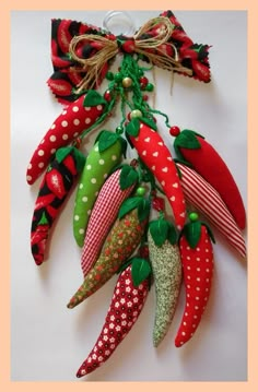 a bunch of fake strawberries are hanging on a string with polka dots and green leaves