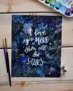 a card with the words i love you more than we are stars on it next to paintbrushes and watercolors