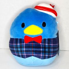 a blue stuffed bird with a red bow tie and plaid shirt on it's chest