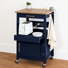 a kitchen cart with a toaster and microwave on it