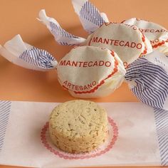 three cookies sitting on top of a piece of paper next to some wrapped up napkins