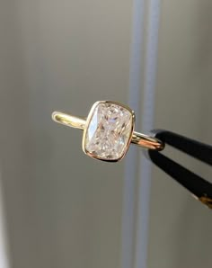 a close up of a ring with a diamond on it