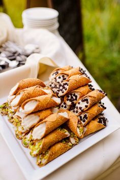 there are many desserts on the table ready to be eaten at this outdoor event