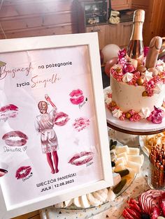 a table topped with cakes and desserts covered in pink frosting next to a cake