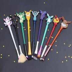 six different types of makeup brushes on a black surface with stars in the back ground