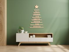 a christmas tree made out of wooden planks on a wall in a living room