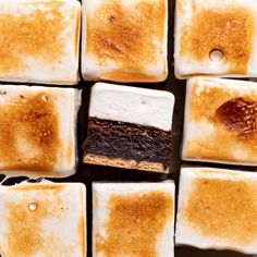 several squares of brownies with marshmallows and chocolate on them, arranged in the shape of squares