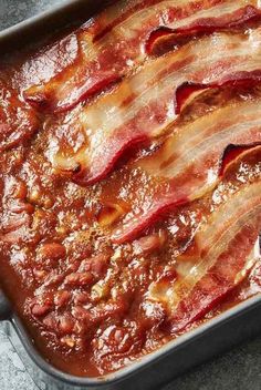 bacon is cooked in a pan on the table