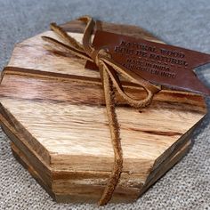 a wooden box with a leather tag tied to it