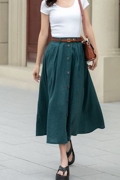 Showcase your style in a sophisticated mid-calf A-line skirt, beautifully tailored in a lush shade of green. The skirt features a distinctive button detail that adds a unique touch. Ideal for the blooming season of spring, this skirt is a perfect addition to any plus size wardrobe.  DETAIL * 100% Linen * Two side pockets * Back elastic waist * Button front skirt * Below Knee Length * Midi skirt  * A Line skirt * Perfect for Spring, Summer and Autumn * Wash by hand or machine with cold water * Mo Casual Long Skirt With Buttons, Summer Midi Skirt With Button Closure, Workwear Maxi Skirt With Button Closure, Summer Wide Leg Maxi Skirt With Button Closure, Knee-length Summer Skirt With Button Closure, Long Skirt With Button Closure For Day Out, Summer Knee-length Skirt With Button Closure, Long Cotton Skirt With Buttons, Relaxed Skirt With Buttoned Pockets For Spring