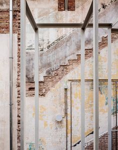 an old building with stairs and graffiti on the walls