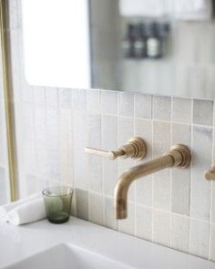 a bathroom sink with two wooden faucets on it