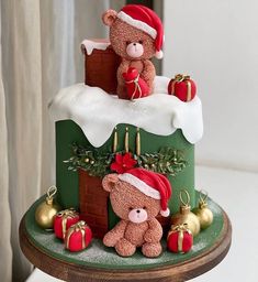 a teddy bear is sitting on top of a christmas cake