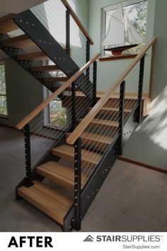 an image of a stair railing installed in a house with wood and metal handrails