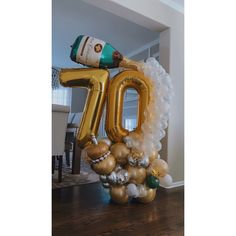 an inflatable balloon shaped like the number ten with a bottle of champagne on top