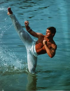 a man in the water doing a kick up