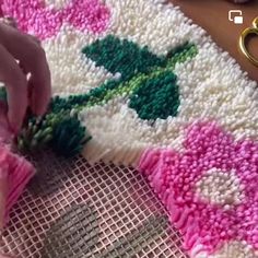 someone is making a rug with crochet and yarn